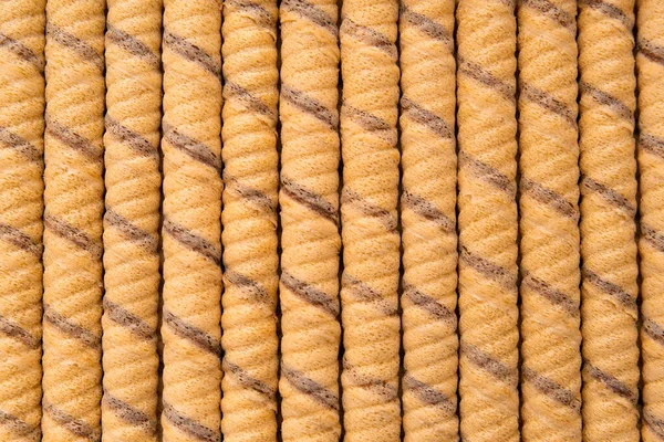 Crispy wafer rolls close-up as a background with space for text. Background of beautifully laid out sweet crispy wafers copy space.