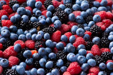 Background from healthy fruits. Blueberries, blackberries and raspberries. Flat lay. Vitamins in natural products. Berries.