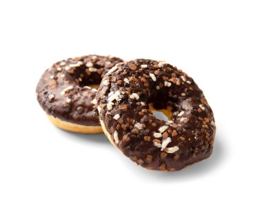Two donuts in chocolate glaze sprinkled with pieces of white, milk and dark chocolate isolated on a white background top view. High-calorie junk food. Sweet snack. Baking for breakfast.