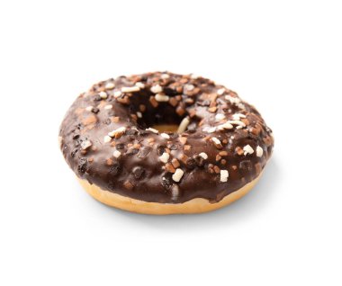 One donut in chocolate glaze sprinkled with pieces of white, milk and dark chocolate isolated on a white background. High-calorie junk food. Sweet snack. Baking for breakfast.