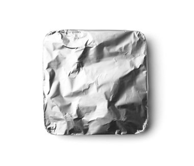 A bar of chocolate is wrapped in silver foil on a white background top view. Chocolate in foil packaging on isolation.