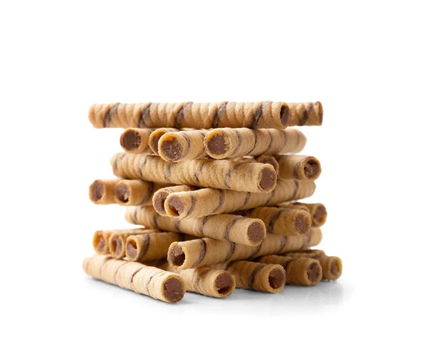 Crispy wafer rolls with chocolate cream are stacked in a beautiful slide on a white background. Pile of crispy wafer sticks with creamy chocolate filling on isolation.