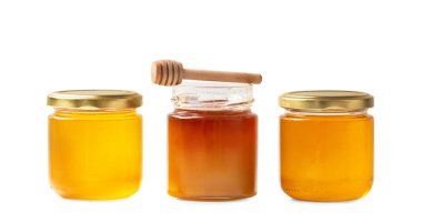 Conceptual composition of open and closed jars with different honey and dipper on isolation. Multi-colored honey in jars on a white background close-up. Honey of various types in glass jars.