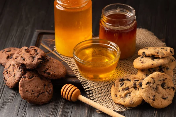 Honey Open Jars Bowl Dipper Homemade Cookies Chocolate Chips Wooden — Stock Fotó