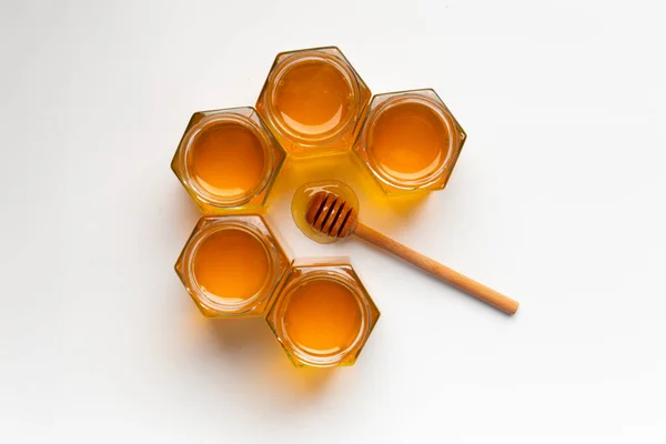Creative Composition Honey Open Jars Form Honeycombs Wooden Dipper White — Stock fotografie