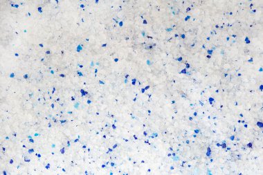 Silica gel white with blue crystals cat litter close-up. Abstract background of pure silica gel crystals.