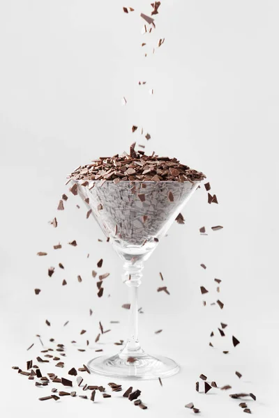 Creative Composition Chocolate Chips Poured Martini Glass Isolated White Background — Stock Photo, Image