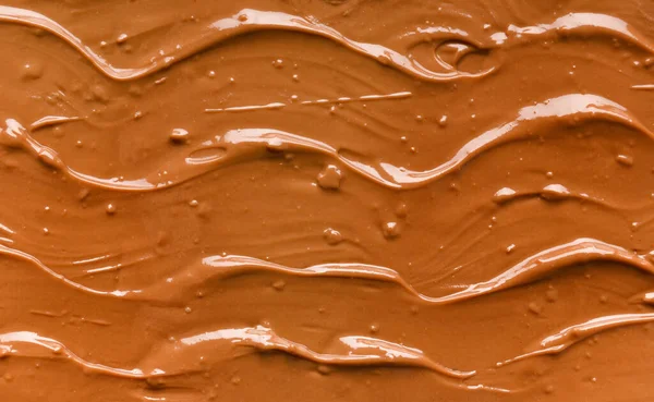 Chocolate background. Melted chocolate. Liquid milk chocolate. Handmade chocolate.