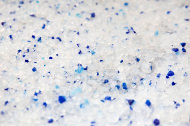 Silica gel white with blue crystals cat litter close-up. Abstract background of pure silica gel crystals.