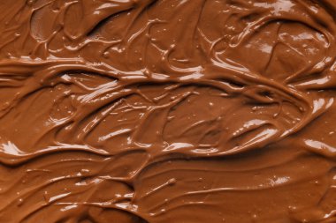 Chocolate background. Melted chocolate. Liquid milk chocolate. Handmade chocolate.