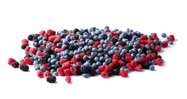 Fresh organic berries close-up isolated. Colorful composition of blueberries, raspberries, blackberries on a white background. Useful berries.