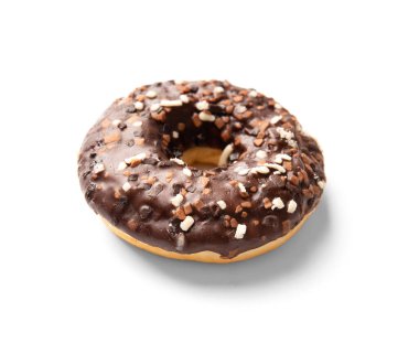 One donut in chocolate glaze sprinkled with pieces of white, milk and dark chocolate isolated on a white background. High-calorie junk food. Sweet snack. Baking for breakfast.