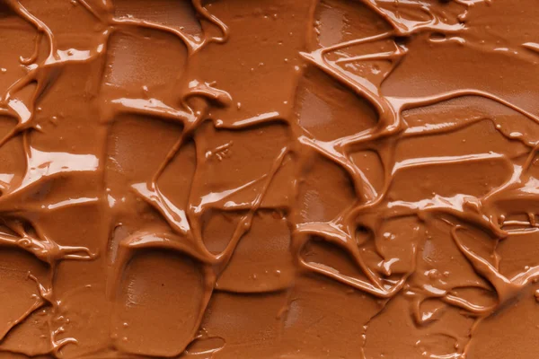 Chocolate background. Melted chocolate. Liquid milk chocolate. Handmade chocolate.