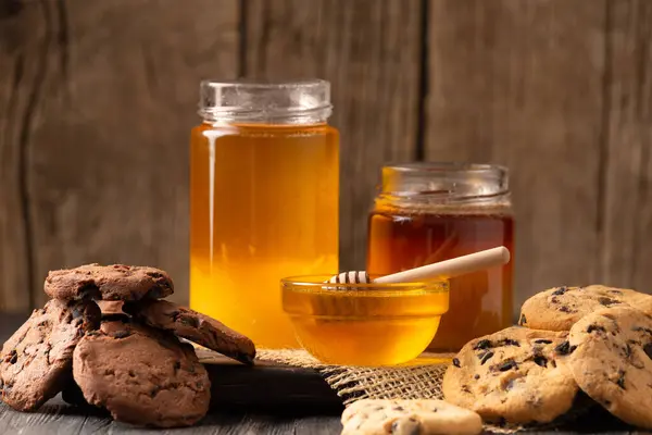 Honey Open Jars Bowl Dipper Homemade Cookies Chocolate Chips Wooden — Stock Fotó