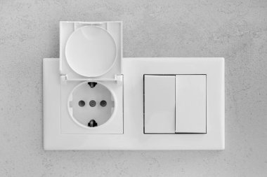 Closed socket and switch on porcelain stoneware in the bathroom