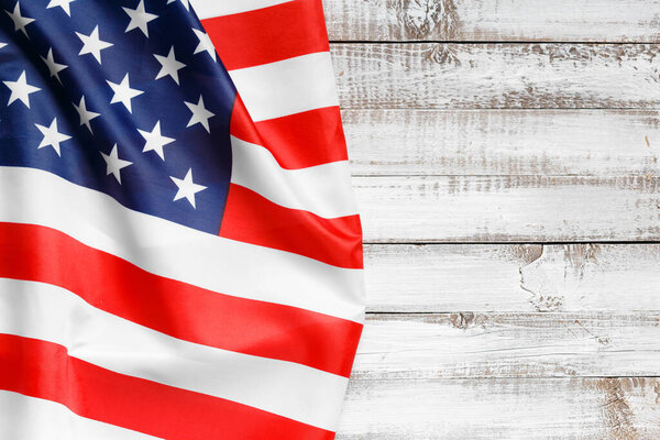 Stars and stripes american flag on rustic wooden background, top view, copy space. The pride of the American people. Symbol of independence, freedom and patriotism in the USA