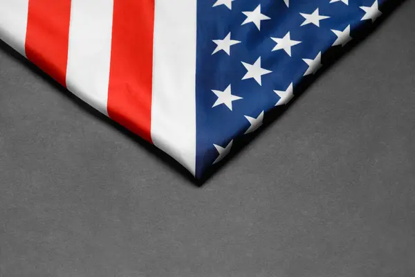 Stars and stripes american flag on a black background, top view, copy space. The pride of the American people. Symbol of independence, freedom and patriotism in the USA