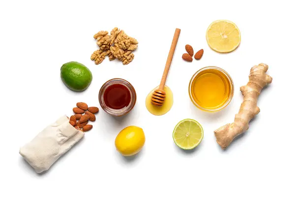 Conceptual Composition Honey Jars Dipper Walnuts Almonds Lemon Lime Ginger — Stock Photo, Image