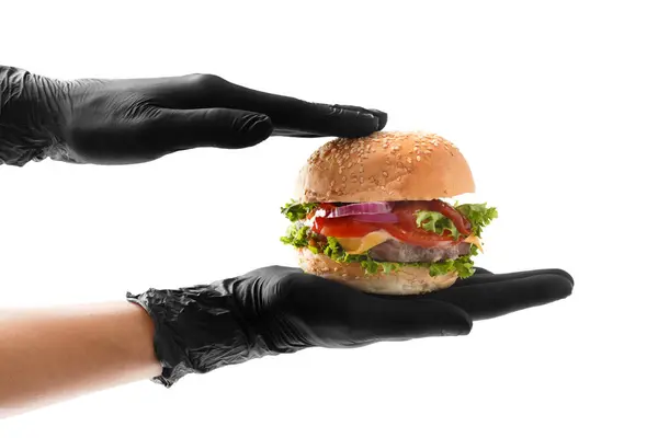 Hände Schwarzen Handschuhen Halten Einen Saftigen Appetitlichen Rindfleisch Burger Auf lizenzfreie Stockbilder