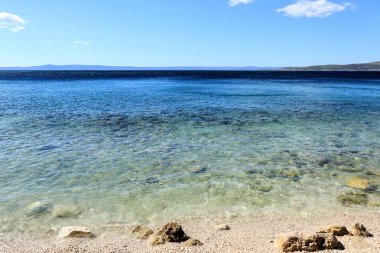 the clear blue sea of Baska Voda, Croatia clipart