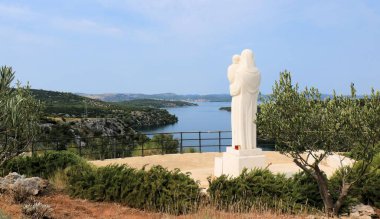 statue looking over the sea, near Skradin, Croatia clipart