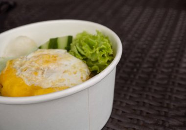 Close up photo fried rice with eggs and lettuce. The photo is suitable to use for traditional food background, poster and food content media.
