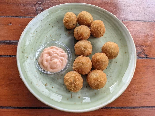Chicken Ball on the green plate with mayonnaise sauce, snack menu on coffee shop. The photo is suitable to use for traditional food background, poster and food content media.
