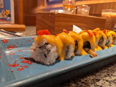 Close up sushi tamago mayonnaise with toping cheese cedar. The photo is suitable to use for Japan traditional food background, poster and food content media.