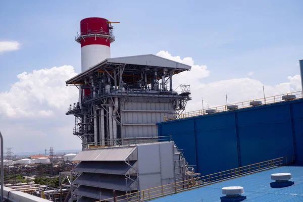 aerial view of combine cycle project power plant when day time with blue sky and cloudy vibes. The photo is suitable to use for industry background photography, power plant poster and electricity.