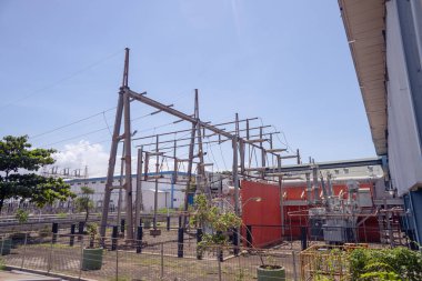 Photo of transformer and switch gear for electricity power plant. The photo is suitable to use for industry background photography, power plant poster and electricity content media.