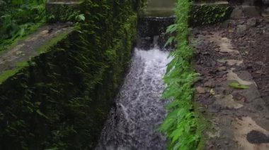 Footage of small water fall on tropical forest. Water flowing through river stone. The footage is suitable to use for nature footage, and travel destination footage.