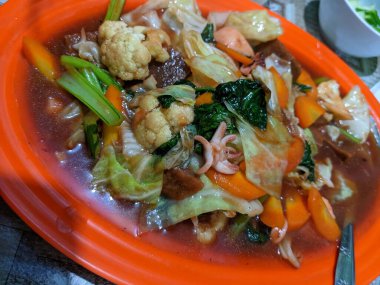 Capcay traditional Chinese food with full vegetables and chicken sausage. The photo is suitable to use for traditional food background, poster and food content media.