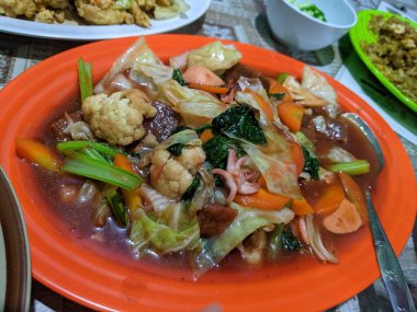 Capcay traditional Chinese food with full vegetables and chicken sausage. The photo is suitable to use for traditional food background, poster and food content media.