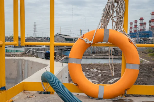 Safety flotation ring on water storage and water treatment area, for emergency action. The photo is suitable to use for safety background photography, power plant poster and electricity content media.