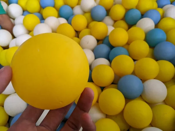 Lot of small ball on kids playground, blue, yellow and white. The photo is suitable to use for playground background, kids toys content media and bath ball poster.