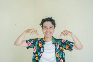 Kıvırcık adam plaj kıyafeti giyer. Küçük resim ve halka pozu. Fotoğraf, insan ifadesi reklamcılığı ve ekommerce içeriği medyası için kullanılabilir.