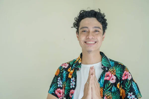Young curly man wear beachwear with greeting pose. The photo is suitable to use for man expression advertising, fashion life style.