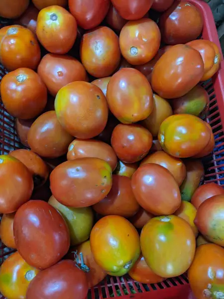 Lot of red tomato fruit on the rack. The photo is suitable to use for fruit and vegetable background and promotion content media.