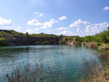 a beautiful shot of the lake with a river, blue sky and clouds, the concept of nature