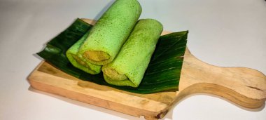 Kue dadar gulung (Sweet coconut pancake), Indonesian dessert made from flour with grated coconut mixed with palm sugar. Selected focus.