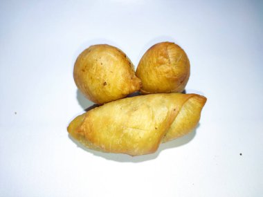 Fried banana wrap indonesian traditional food. The taste is sweet, crunchy outside and soft inside. top view of Pisang molen, Indonesian traditional food made from banana wrap with sheet of pastry dough and then fried. Isolated with white background