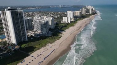This 4K aerial drone footage captures the stunning oceanfront condos in Florida, set against the backdrop of the beautiful sandy beach and the majestic waves of the Atlantic Ocean.