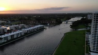 This 4K aerial drone footage captures the mesmerizing movement of boats on the Intracoastal Waterway as the sun sets, creating a hyperlapse effect.