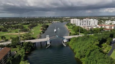 This HD 1080P aerial drone footage captures the impressive sight of a drawbridge opening over the Intracoastal Waterway. The video offers a unique perspective of the bridge as it rises to allow boats and ships to pass through. 