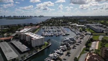 This HD 1080P aerial drone footage captures the bustling activity of a marina, showcasing the boats and yachts docked at the harbor. The bird's-eye view provides a stunning perspective of the marina and the waterfront. 