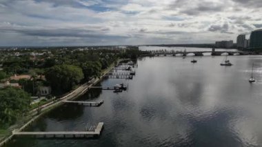 Explore the picturesque docks on the Intracoastal Waterway with this 4K aerial video. The footage provides a bird's-eye view of the area, showcasing the dock's design, the boats moored.