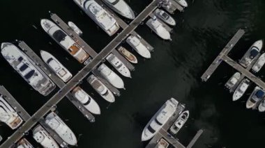 This 4K aerial video offers a unique straight-down view of boats floating on the water. The footage showcases the boats' design, colors and size. 