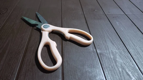 dirty scissors with pink handles on the table
