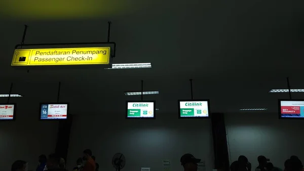 queue of people buying tickets at the airport