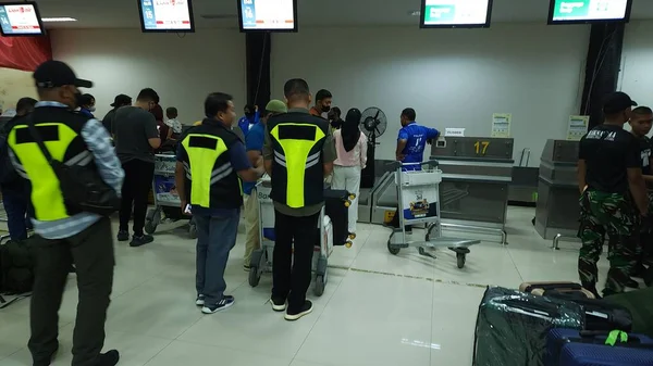 queue of people buying tickets at the airport